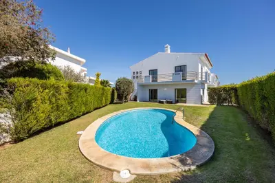a swimming pool in the yard of a house at The Green Sheep Sagres in Sagres