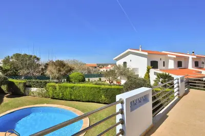 a villa with a swimming pool and a house at The Green Sheep Sagres in Sagres