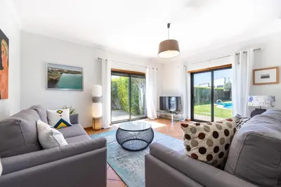 a living room with two couches and a tv at The Green Sheep Sagres in Sagres