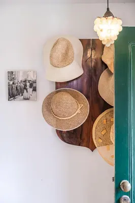 a group of straw hats hanging on a wall at Casa dos Castanheiros in Camacha
