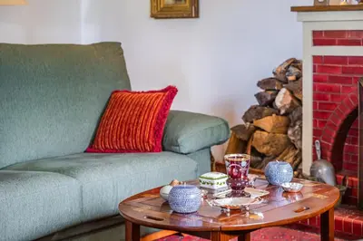 a living room with a couch and a coffee table at Casa dos Castanheiros in Camacha
