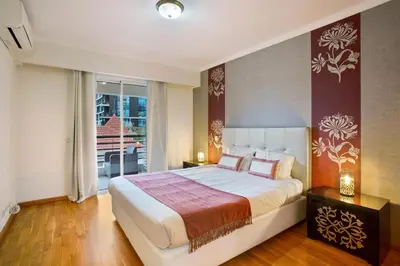 a bedroom with a large bed and a balcony at Apartamento Caires in Funchal