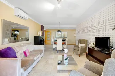 a living room with a couch and a table at Apartamento Caires in Funchal