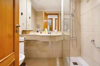 a bathroom with a sink and a shower at Apartamento Caires in Funchal