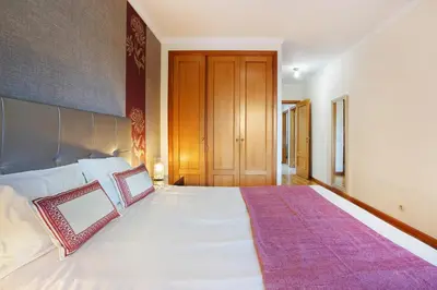a bedroom with a large white bed with two pillows at Apartamento Caires in Funchal