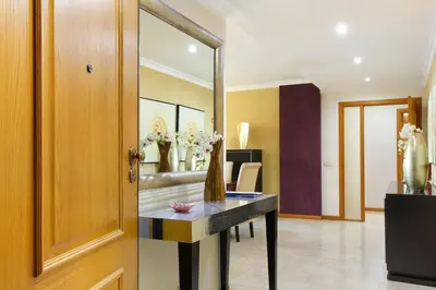 a room with a table and a mirror at Apartamento Caires in Funchal