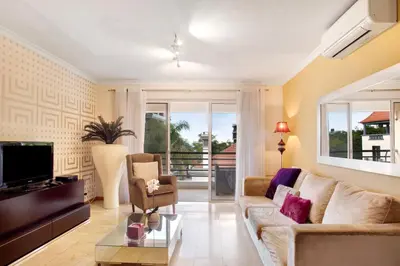 a living room with a couch and a tv at Apartamento Caires in Funchal
