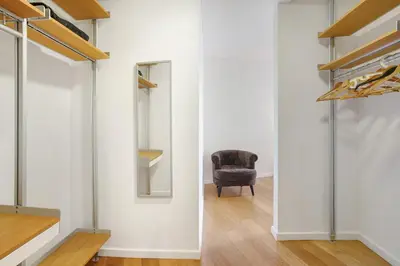 a room with a chair and a mirror at Apartamento Forum View in Funchal