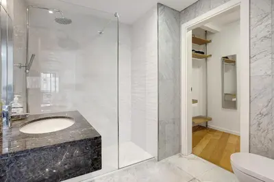a bathroom with a sink and a glass shower at Apartamento Forum View in Funchal