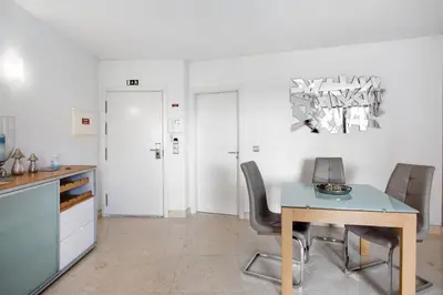 a kitchen and dining room with a table and chairs at Apartamento Forum View in Funchal