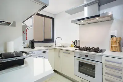a kitchen with white counters and a stove top oven at Apartamento Forum View Studio in Funchal