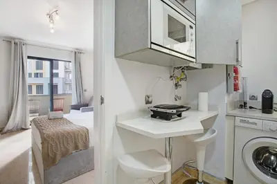 a small kitchen with a sink and a washing machine at Apartamento Forum View Studio in Funchal