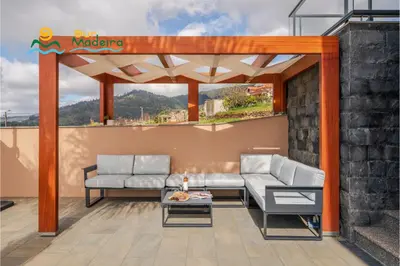 a patio with two couches and a table at OurMadeira - OceanScape in Madalena do Mar