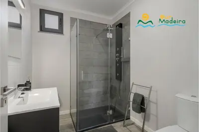 a bathroom with a sink and a shower at OurMadeira - OceanScape in Madalena do Mar