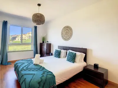 a bedroom with a bed and a large window at Vista Atlântica by LovelyStay in Caniço
