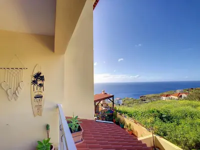 a staircase leading to a house with a view of the ocean at Vista Atlântica by LovelyStay in Caniço