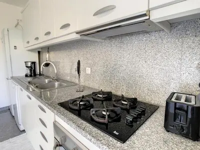 a kitchen with a stove and a sink in it at Vista Atlântica by LovelyStay in Caniço