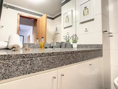 a bathroom with a sink and a counter top at Vista Atlântica by LovelyStay in Caniço