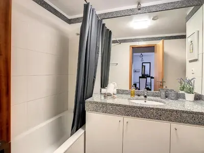 a bathroom with a sink and a tub at Vista Atlântica by LovelyStay in Caniço
