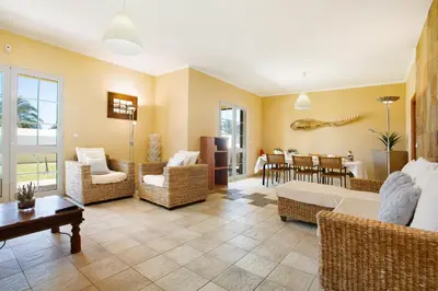 a living room with a couch and chairs and a table at Retiro Praia in Campo de Baixo