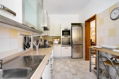 a kitchen with a sink and a refrigerator at Retiro Praia in Campo de Baixo