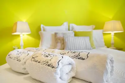 a bedroom with blue walls and a bed and a window at Retiro Praia in Campo de Baixo