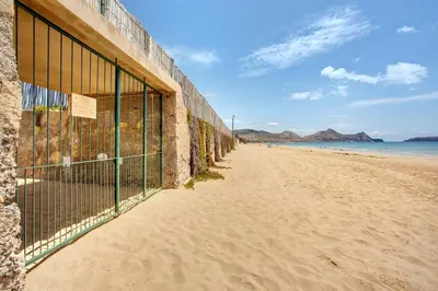 a fence on the side of a sandy beach at Retiro Praia in Campo de Baixo
