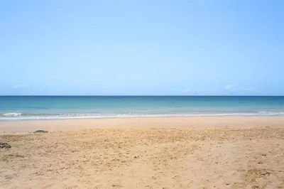 a sandy beach with the ocean in the background at Retiro Praia in Campo de Baixo