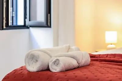 a pile of towels sitting on top of a bed at Casa do Porto in Paul do Mar