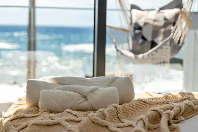 a bedroom with a large white bed with yellow pillows at Casa Homem do Mar in Paul do Mar