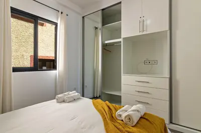 a bedroom with a bed with towels on it at Casa Homem do Mar in Paul do Mar