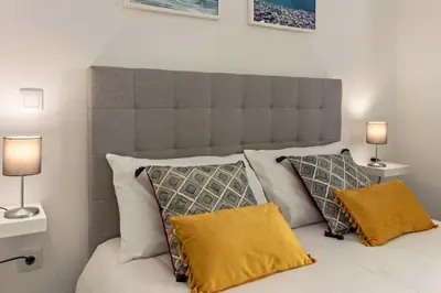 a bedroom with a large bed with two lamps at Casa Homem do Mar in Paul do Mar
