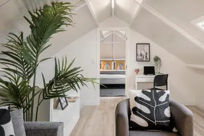 a living room with a chair and a desk at Casa da Lombada by An Island Apart in Funchal