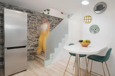 a dining room with a white table and green chairs at Casa da Lombada by An Island Apart in Funchal