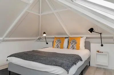 a bedroom with a bed with orange and white pillows at Casa da Lombada by An Island Apart in Funchal