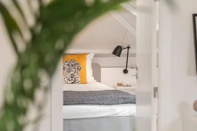 a bedroom with a bed with orange and white pillows at Casa da Lombada by An Island Apart in Funchal