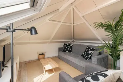 a living room with a gray couch and a ceiling at Casa da Lombada by An Island Apart in Funchal