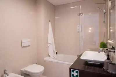 a bathroom with a toilet and a sink and a shower at Comboio I by An Island Apart in Funchal