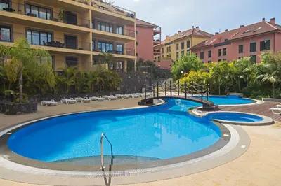 a large swimming pool in front of a building at Comboio I by An Island Apart in Funchal