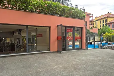 a store front with glass doors on a street at Comboio I by An Island Apart in Funchal