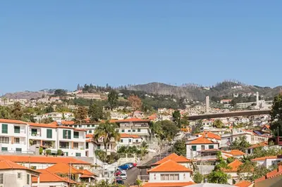 a view of a city with houses at Comboio I by An Island Apart in Funchal