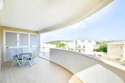 a balcony with a chair and a view of the city at POLA SeaView Apartment by MOJE Holiday in Lagos