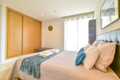 a bedroom with a large bed with towels on it at POLA SeaView Apartment by MOJE Holiday in Lagos