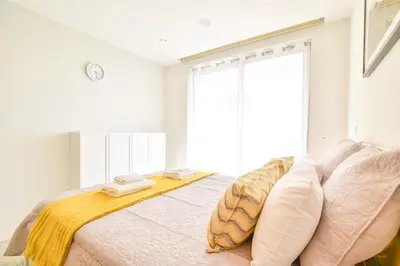 a bedroom with a bed with two towels on it at POLA SeaView Apartment by MOJE Holiday in Lagos