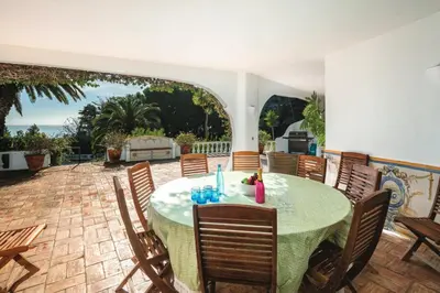 a patio with a table and chairs on a patio at Quinta Kilara in Luz