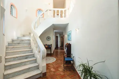 a staircase in a home with white walls at Quinta Kilara in Luz