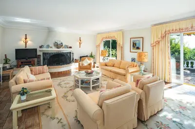a living room with couches and a fireplace at Quinta Kilara in Luz