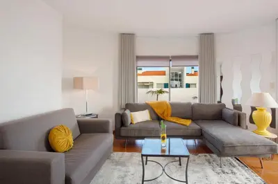 a living room with two couches and a table at Apartamento Lolita com Terraço in Caniço