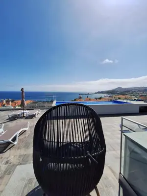 a black bench sitting on top of a roof at Apartments Madeira Barreirinha in Funchal