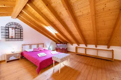 a bedroom with a bed and a wooden ceiling at Casa Joia by Seewest in Bensafrim